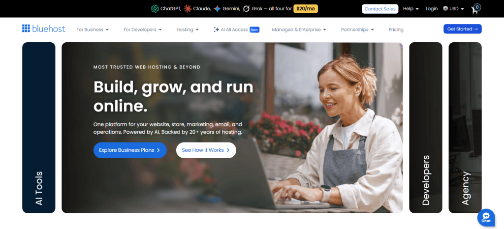 A smiling small-business owner in an apron working on a laptop near flowers, promoting web hosting and business-building tools on Bluehost.